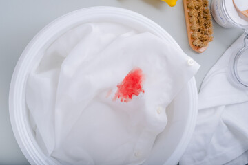 Homemade eco-friendly removing of stains on clothes with baking soda. Dirty blood stains on white...