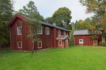 Fototapeta na wymiar Old traditional style red wooden buildings, Finland.