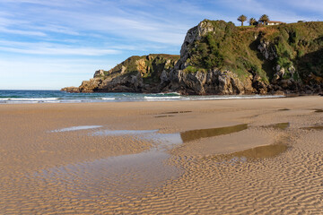 Amio beach with the cliffs and rock formations at sunset in Cantabria, Spain