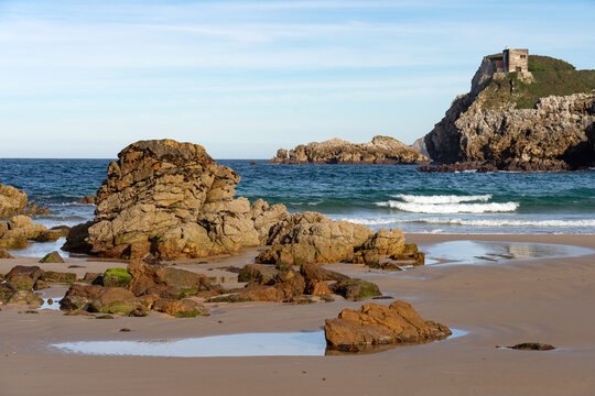 Amio beach with the cliffs and rock formations at sunset in Cantabria, Spain