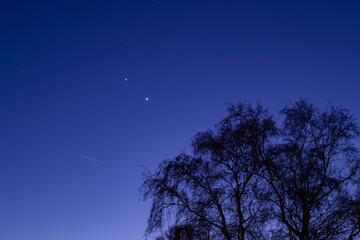 Jupiter and Saturn planets in the night sky appearing as a rare phenomenon at dusk during winter. The Great Conjunction an amazing and historical astronomical event at the end of day in Holland