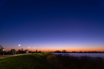 Jupiter and Saturn planets in the night sky appearing as a rare phenomenon at dusk during winter. The Great Conjunction an amazing and historical astronomical event at the end of day in Holland