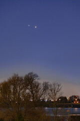Jupiter and Saturn planets in the night sky appearing as a rare phenomenon at dusk during winter. The Great Conjunction an amazing and historical astronomical event at the end of day in Holland