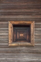 Old weathered window on an traditional wooden barn. Finland.