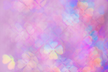 Floral figured Bokeh in purple Hues, Colorful Abstract bokeh background, natural flare from lights, blurred clover leaves shapes texture as holiday backdrop, celebration idea with optical effect