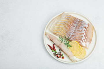 Raw pollock (Pollachius virens) fillet. Fresh fish for healthy food lifestyle. Spices and herbs