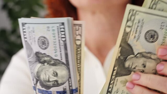 Hands counting one hundred dollar bills in office. Stack of hundred dollar bills. Banknotes in hands close-up. World economy. Currency exchange. Cash payment. Businessman counts dollar bills. Finance