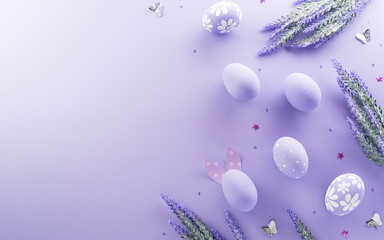 Easter party concept. Top view of easter bunny ears and colorful eggs on pastel background with copyspace for the text.