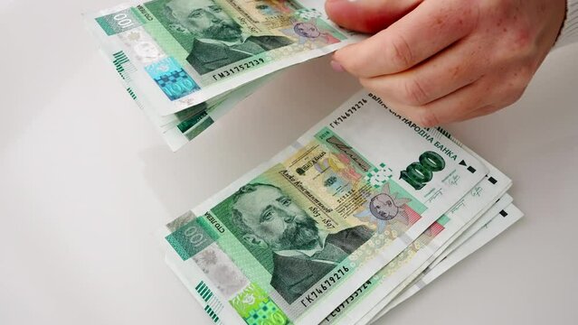 Counting money 100 lev Bulgarian woman hands in paper banknotes bills in office. Stack of hundred lev bills. Banknotes in hands close-up. Bulgarian economy Eurozone. Currency exchange. Cash payment