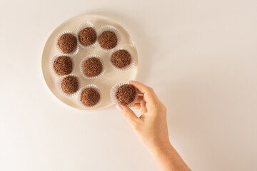 Brigadeiro brazilian chocolate balls party candy with chocolate flakes aerial view clean background