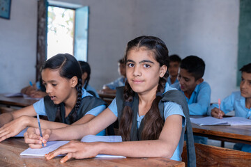 Group of indian village students in school uniform sitting in classroom studying. Selective Focus, Education concept