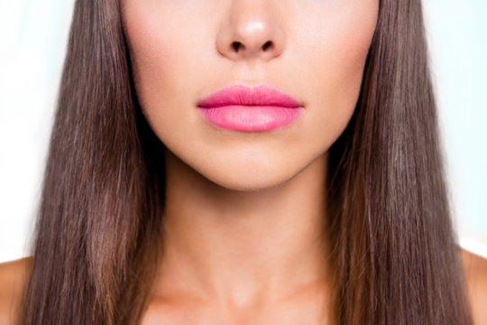 Close-up portrait of young gorgeous nice cute attractive perfect smiling girl face, cosmetology, lips perfection. Isolated over bright vivid turquoise background
