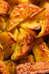 Close-up of Crispy potato wedges baked with seasonings.