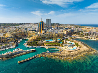 St. Julian's city and modern high buildings, hotel complex. Day, drone. Maltese island