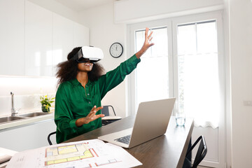 A black afro girl architect is demonstrating  and working on her virtual reality home projects...