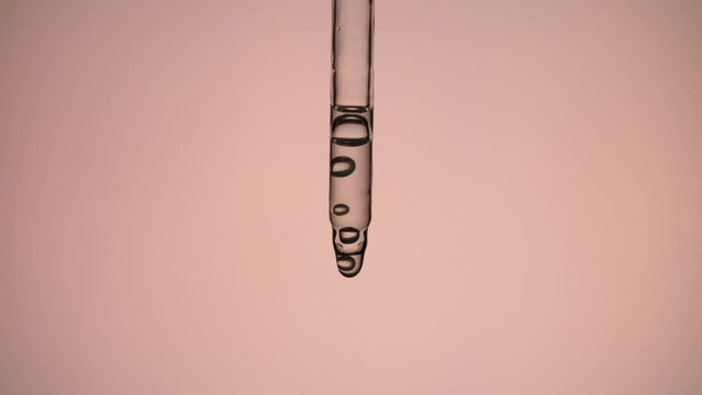 Applying cosmetic product on pink background