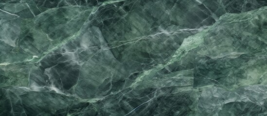 A close-up view of a green marble texture background, showcasing the intricate patterns and details of the natural stone. The surface appears smooth yet with visible veins and specks creating a unique