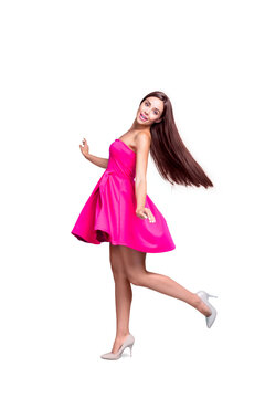Full length size body vertical picture of young straight-haired sweet tender brunette smiling girl, wearing pink mini short dress, dancing, spinning. Isolated over bright vivid turquoise background