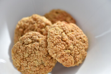 Oatmeal cookies on a white plate. Healthy food for breakfast or a snack. Close up. Soft focus - 755642867