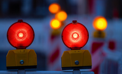 Traffic barring with two red battery flash lights indicating road closure, “no entry“ or “do...