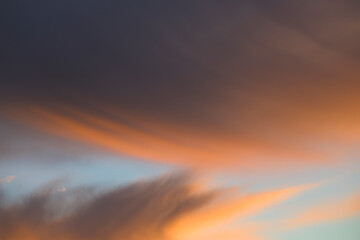 Windy cloud sky wallpaper at sunset with orange tones horizontally