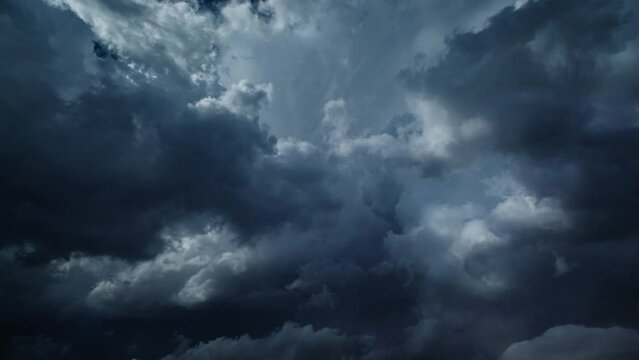 Storm clouds and lot of lightning during a thunderstorm. Dramatic clouds moving fast, 4k