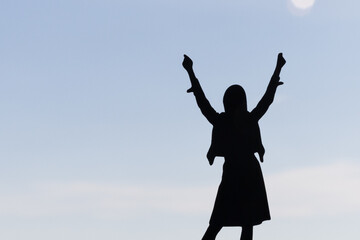 Female silhouette, business success, business victory, hands up, women's rights day. The young...