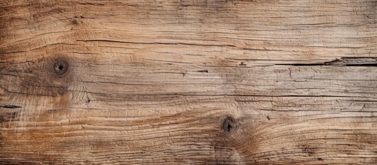 A close-up view of a light brown aged wooden surface with knots, cracks, and scuffs visible. The texture of the wood adds character and depth to the image.