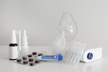 Inhaler, digital thermometer, first aid kit, nasal spray and pills