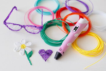 3d pen, kit of colourful plastic filament, flower, glasses and heart