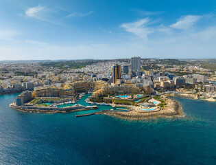 Aerial view of St. Julian's city and modern high buildings. Day. Maltese island, Mediterranean sea