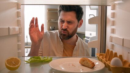 Point of view from inside refrigerator POV Caucasian adult man householder homeowner open fridge...
