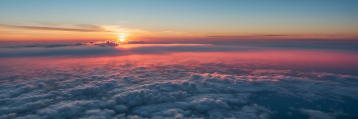 Sun Setting Over Clouds in Sky - obrazy, fototapety, plakaty