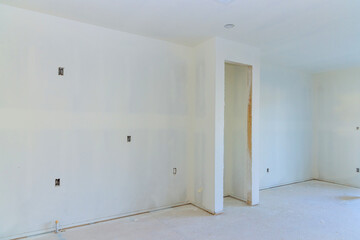 Having completed painting decorating work on new house, preparing walls for final painting