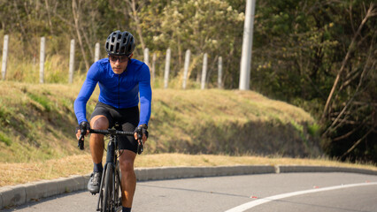 Obraz premium Man riding bicycle on a road outdoors