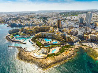Obraz premium Aerial drone view of St. Julian's city, modern high buildings. Day. Maltese island, Mediterranean sea