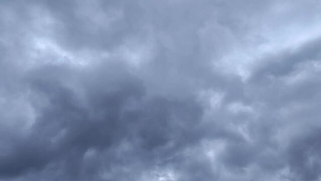 The light begins to reach the large gray cloud cluster