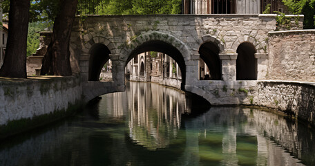 bridge over a small canal in the style of Italy