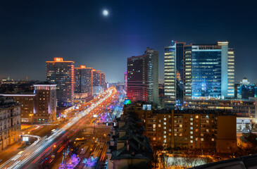 Fototapeta premium New Arbat Street, highway with moving cars at moony night in Moscow, Russia