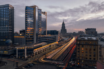 Fototapeta na wymiar Smolenskaya Square highway and moving cars in evening Moscow, Russia, long exposure
