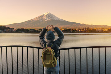 Woman tourist with Fuji Mountain at Lake Kawaguchi, happy Traveler sightseeing Mount Fuji in...