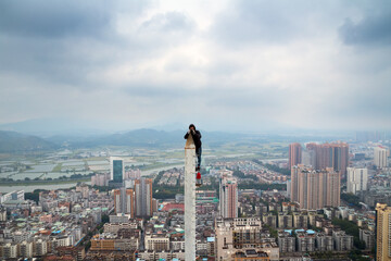 Roofer shoots from tall spire in residential area in Hong Kong, China