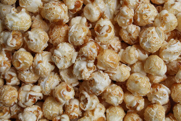 Background texture of caramel popcorn. Popcorns coated by melted sugar