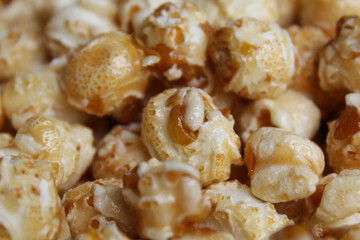 Background texture of caramel popcorn. Popcorns coated by melted sugar