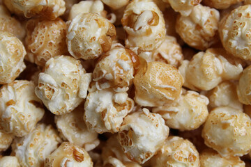 Background texture of caramel popcorn. Popcorns coated by melted sugar