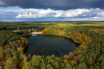 Aerial shot of beautiful lake surrounded by forest in a calm autumn day. Germany. - 755683628