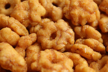 Background texture of Sakura Ribut, fried dough with flower shape, coated with seasoning powder. Snack from Indonesia