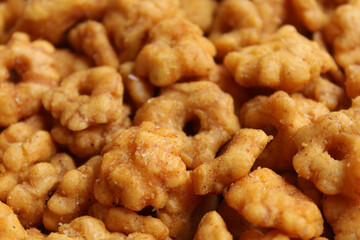 Background texture of Sakura Ribut, fried dough with flower shape, coated with seasoning powder. Snack from Indonesia