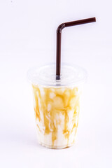 Iced Caramel Milk. Beverage for summer with brick wall background.
