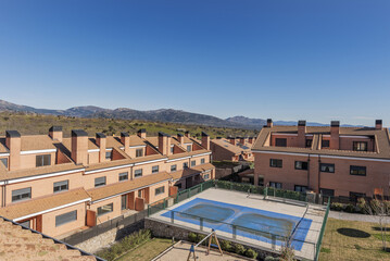 An urbanization of semi-detached single-family homes with a swimming pool in the common areas